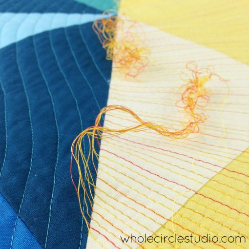 Burying sun ray threads in Sun Salutation quilt. Quilt pattern by www.wholecirclestudio.com