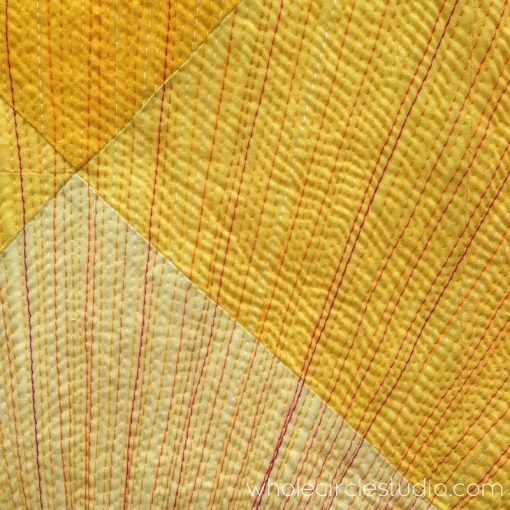 Detail of quilting sun rays in Sun Salutation quilt. Quilt pattern by www.wholecirclestudio.com