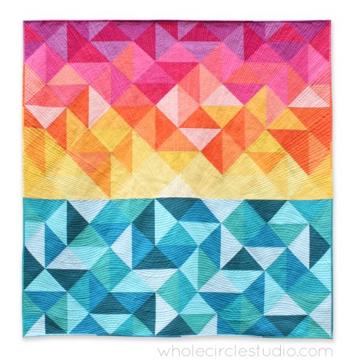 Sun Salutations, a modern spin on the traditional half square triangle quilt block. A beautiful gradient of solid fabrics lend itself to this Hawaiian-inspired sunrise quilt design. Pattern by Whole Circle Studio.