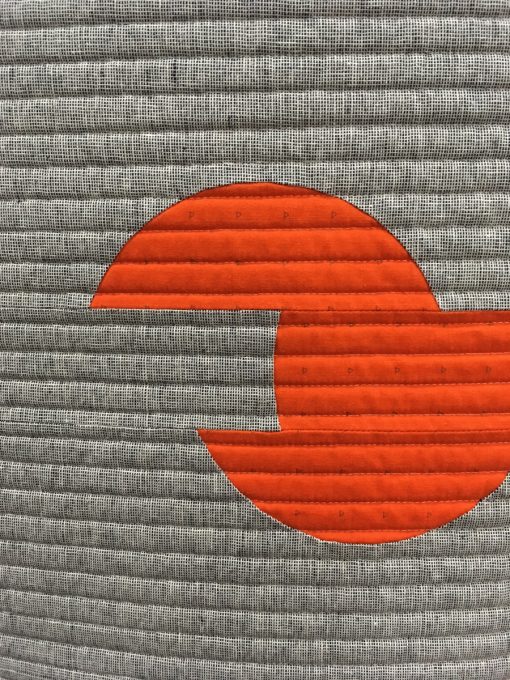 detail of "Sliced Circles" by Karen H. Lee. Quilted by Christina Lane. Modern Minimalist Design quilt