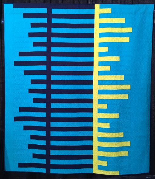 "Periodicity" by Cheryl Brickey Statement: "Periodicity shows the beauty and rhythm of periodic waves in this high contrast and vibrant quilt. It was quilted with horizontal rows of loops using a matching thread color for each section to give the quilt texture but not take away from the bold fabrics.” [Design Source: Periodic waves] displayed in the 2018 Modern Quilt Showcase sponsored by the Modern Quilt Guild at the International Quilt Festival in Houston