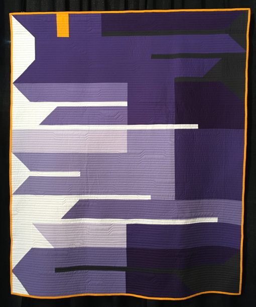 "Fringe Area" by Heather Black. Statement: "Fringe Area was designed for this year's Pantone Color of the Year quilt challenge. The Color of the Year for 2018 is ultra-violet, and I wanted a design that featured almost entirely shades of purple. I named the quilt Fringe Area because ultra-violet is just out of the range of visual light on the electromagnetic wave scale.” [Design Source: Pantone Color of the Year] displayed in the 2018 Modern Quilt Showcase sponsored by the Modern Quilt Guild at the International Quilt Festival in Houston