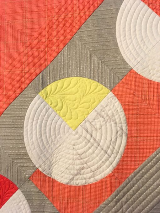 detail of "Give and Take" by Kari Vojtechovsky. Quilted by Christine Perrigo displayed in the 2018 Modern Quilt Showcase sponsored by the Modern Quilt Guild at the International Quilt Festival in Houston