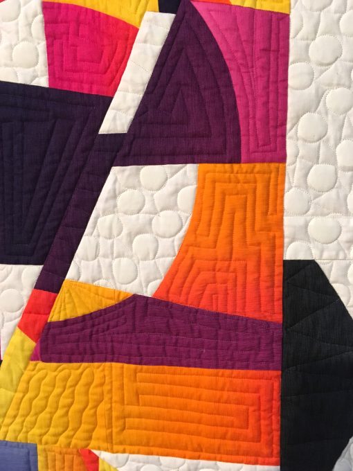 detail of "Mid-Century Modern Curve #1" by Carole Lyles Shaw. Quilted by Carol Byrnes. displayed in the 2018 Modern Quilt Showcase sponsored by the Modern Quilt Guild at the International Quilt Festival in Houston