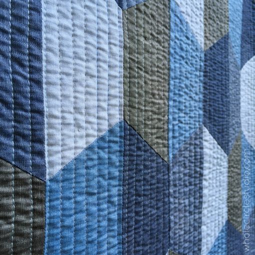 Detail of Hexie Blues quilt. Made with Art Gallery Fabrics Denim Studio (variety of colors) and pieced and quilted with Aurifil Cotton Thread. Batting: Warm and Natural by The Warm Company. Pattern by Whole Circle Studio