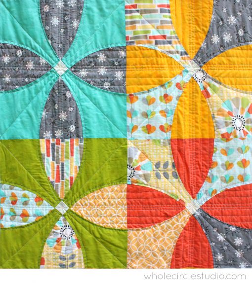Detail of Picnic Petals is a modern quilt based on a traditional Flowering Snowball block. Pattern by Whole Circle Studio.