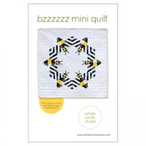 Bzzzzzz is an award-winning modern, graphic wallhanging/mini quilt featuring a combination of traditional machine piecing and foundation paper piecing. Make additional blocks to make a larger quilt (layout ideas are provided to make a lap, twin or queen quilt). This tested pattern contains both detailed instructions and diagrams, making it easy to piece. Pattern by Whole Circle Studio.