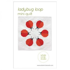 Ladybug Loop is a graphic wallhanging / mini quilt that uses foundation paper piecing techniques. Make additional blocks to make a larger quilt (layout ideas are provided to make a lap, twin or queen quilt). This tested pattern contains both detailed instructions and diagrams, making it easy to piece. Pattern by Whole Circle Studio.
