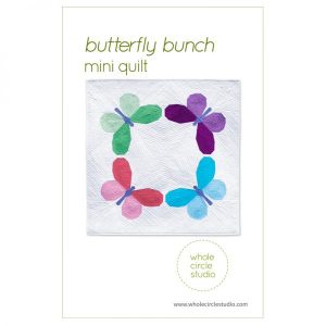 Butterfly Bunch is a fun graphic wallhanging / mini quilt that uses foundation paper piecing techniques. Make additional blocks to make a larger quilt (layout ideas are provided to make a lap, twin or queen quilt). This tested pattern contains both detailed instructions and diagrams, making it easy to piece. Each butterfly block measures 14″ x 14″ making it a flexible design to customize your own quilting project. Use what you have in your fabric stash, fat eighths or fat quarters for the butterflies. Just add yardage for the background! Pattern by Whole Circle Studio.
