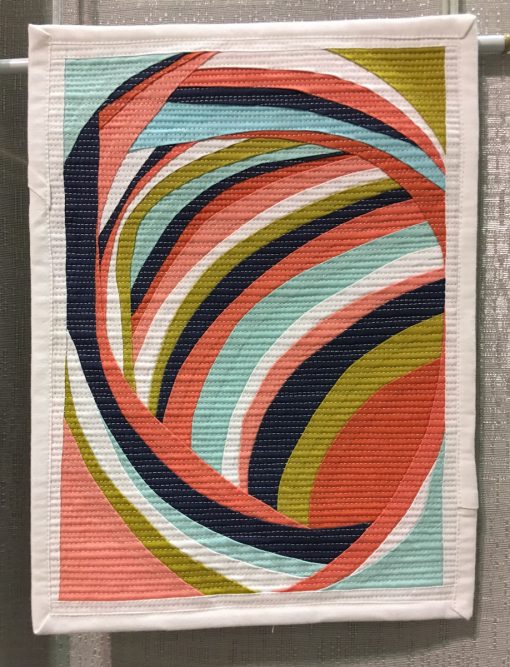 Modern quilt featured at QuiltCon 2019 —“Self portrait” by Melanie Tuazon @melintheattic Statement: “The result of an improv curve process that I found revelatory and exhilarating.”