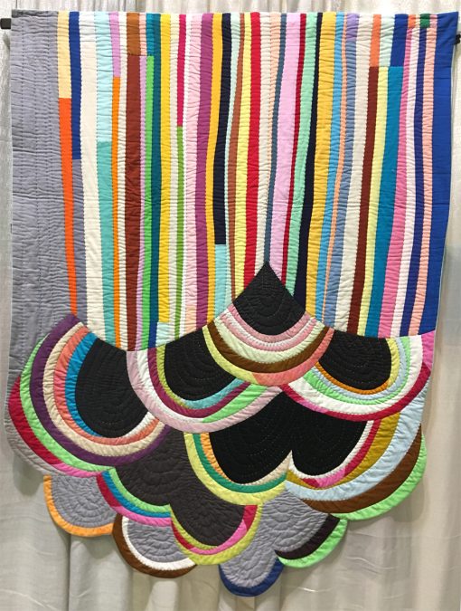 Modern quilt featured at QuiltCon 2019 — “Rainbow Cloud” by Sherri Lynn Wood @sherrilynnwood Statement: “Freestyle patchwork with ruler-free strip piecing and bias strip piecing on the curve, inspired by the bright colors, complexity of line, and unexpected juxtaposition in the grafitti-rich environment of industrial east Oakland, California.