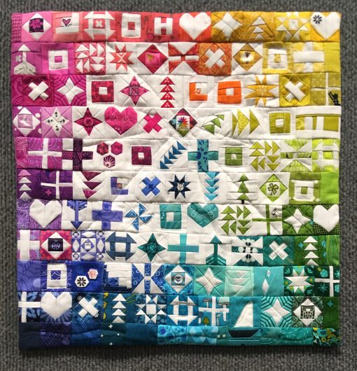 Modern quilt featured at QuiltCon 2019 — “100 Days of Sewing Smaller” by Kitty Wilkin @nightquilter Statement: “My personal challenge was #100daysofsewsmaller. Each of the 100 blocks in this challenge finishes at 1.25” square, and these blocks were eventually made into the mini quilt you see here. The accompanying photos highlight each individual piece, showing the process of creating each tiny block.