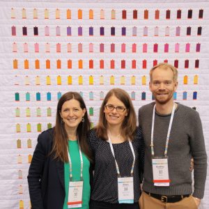 QuiltCon 2016. Erin & Bradley of Aurifil USA with Sheri Cifaldi-Morrill of wholecirclestudio.com, designer and maker of quilt.