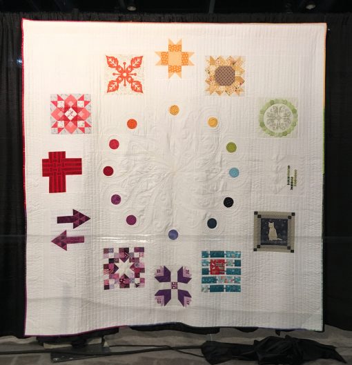 "2017 Designer of the Month Quilt" by Pat Sloan. Quilted by Carolina Asmussen <br>Statement: "Designers starting at the top block are:<br>Brenda Ratliff–Bright Sun Block<br>Vanessa Goertzen-Sunflower Power<br>Helen Stubbings-Basically Hugs<br>Heather Givans-Tall Trees<br>Janet Clare-Cat Applique<br>Amanda Murphy-Tight Rope<br>Maureen Cracknell-Dutch Treat<br>Melissa Corry-Scraptastic Stars<br>Sue Marsh-A New Direction<br>Mathew Boudreux-Faux Weave<br>Sarah Maxwell-Star Shine<br>Shruti Dandekar-Reverse Applique Block [Design Source: Quilt Sampler | Techniques: Hand appliqued, machine pieced and quilted] 