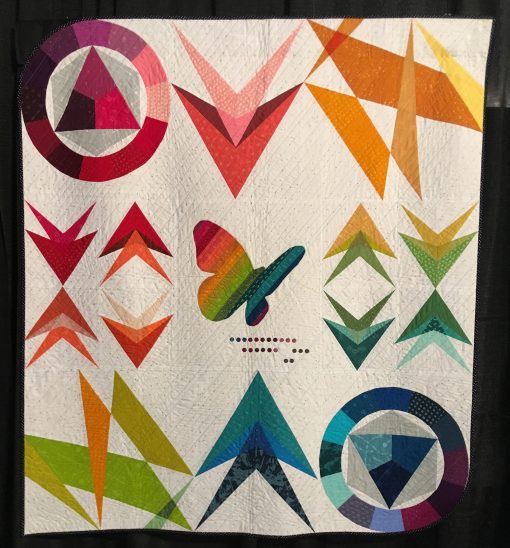 "Neoteric" by Sarah Thomas <br>Statement: "This quilt was developed using the fabric collection, Avant Garde, by Katarina Rocella as inspiration. It includes a range of techniques. Color theory, foundation paper piecing, applique, and translucency all play an important part in this pattern." [Design Source: Inspired by the fabric collection, Avant Garde, by Katarina Rocella | Techniques: Machine pieced, appliqued and quilted] 
