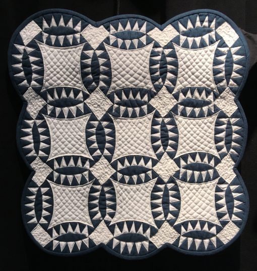 Pickle Dish by Andrea Blackhurst. Techniques: Machine pieced and quilted. Design Source: Miniature Quilts Magazine #35. Photo taken at 2019 International Quilt Festival