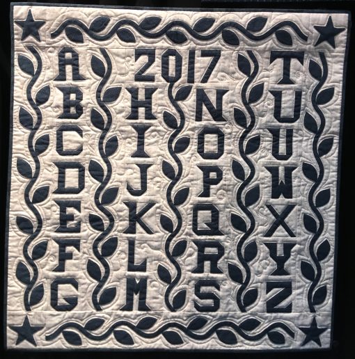 Alphabet Quilt by Andrea Blackhurst. Techniques: Hand appliqued, machine pieced and quilted. Design Source: Antique quilt. Photo taken at 2019 International Quilt Festival