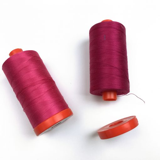 Looking to keep the ends of your Aurifil thread neat and tidy? Did you know you can remove the flange on the bottom of your large spool? Remove it and tuck the end of your thread in!
