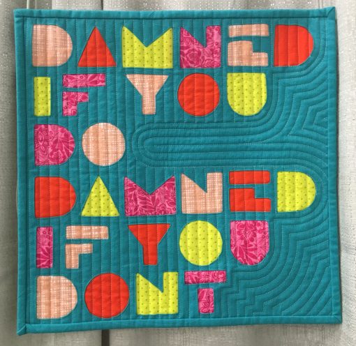 “Damned” by Skye Rayburn @isleofskyestudio Statement: “A familiar saying when things just are not going your way. I thought I would use this phrase as I worked through the different angles of the letters/shapes using the reverse applique technique.” Modern quilt featured in the Small Quilts category at QuiltCon 2020 in Austin, Texas presented by the Modern Quilt Guild.