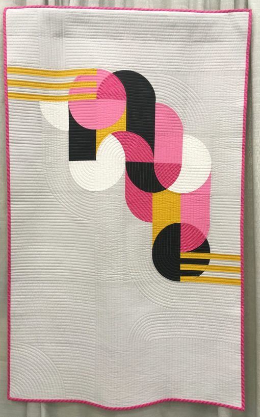“Bubble Gum” by Sophie Zaugg @lunalovequilts Awarded 2nd place in Use of Negative Space category Statement: “The design was inspired by a geometric street art mural. I included the main motif in negative space to showcase it and mimic the concrete wall of the original work. I placed the yellow strips as if they linked the motif to the edge of the quilt. All the curves are hand appliquéd.” Modern quilt featured in the Use of Negative Space category at QuiltCon 2020 in Austin, Texas presented by the Modern Quilt Guild.