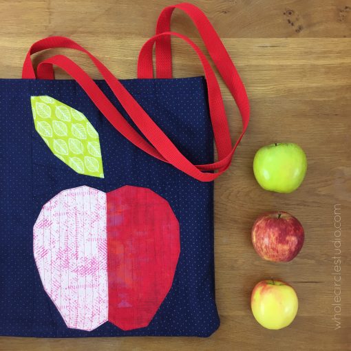 Apple Turnover, a fun modern foundation paper piecing quilt pattern. An easy pattern—instructions included for four sizes: mini, wall, runner, and throw. Designed by Sheri Cifaldi-Morrill of Whole Circle Studio Block incorporated into the Easy Tote, tutorial by Purl Soho.