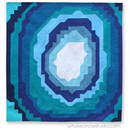 Stone Slice: a modern, easy quilt pattern inspired by geodes, rocks and crystals. This is the perfect quilt pattern to make a gift for a budding geologist or stone / crystal lover! Instructions come in 3 sizes: mini, throw and queen and is friendly for the beginner quilter. Comes together with fabric strips and half square triangles (HSTs). Pattern by Whole Circle Studio