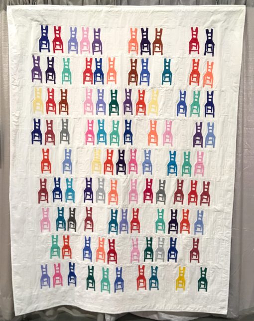 Modern quilt featured at QuiltCon 2019 — “Sit-In” by Frances Dowell @offkilterquilt Statement: “When I saw artist Beverly Buchanan’s drawing of a rustic chair, I was inspired by both its style and bright colors. I envisioned a quilt of similar chairs in neat rows (a la Warhol’s soup cans). But I discovered that I liked the chair in irregular groupings, as though people had pulled them here and there to sit with friends or by themselves. Ghost chairs are quilted in between the appliquéd chairs. I’m still pondering who the ghost chairs belong to and why the remain in the room.” Sources: Beverly Buchanan, Artist—only the design of the chair.