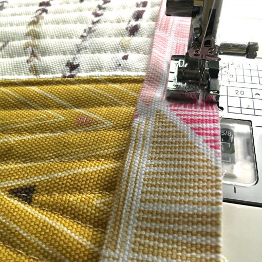 Applying binding to my reversible table runner, made with Art Gallery Fabrics canvas and quilted on my Janome 6700P