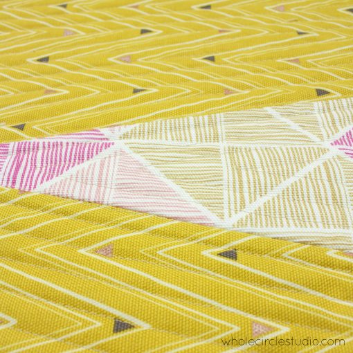 detail of free quilting pattern for a reversible wedge table runner, made with Art Gallery Fabrics canvas. Designed and made by Sheri Cifaldi-Morrill of Whole Circle Studio