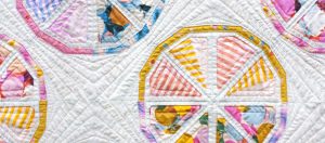 detail of Citrus Slices, a fun modern foundation paper piecing quilt pattern. Designed by Sheri Cifaldi-Morrill of Whole Circle Studio