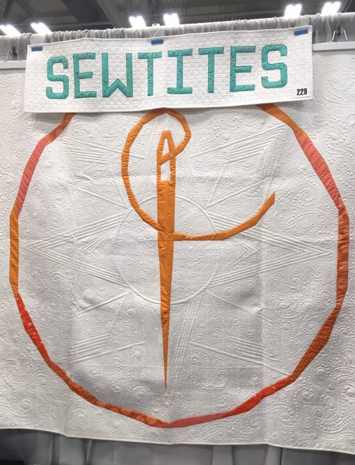 SewTite, magnetic sewing "pins" for bagmaking, English paper piecing, foundation paper piecing, garment and cosplay making, machine embroidery, and more! Booth at QuiltCon 2020. Sign made with Typecast EPP pattern by Whole Circle Studio.