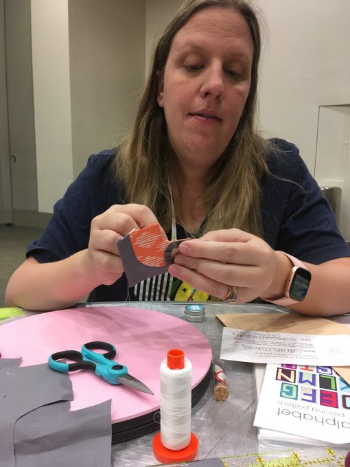 Quilt students practicing English Paper Piecing in Sheri Cifaldi-Morrill's EPP workshop at QuiltCon 2020