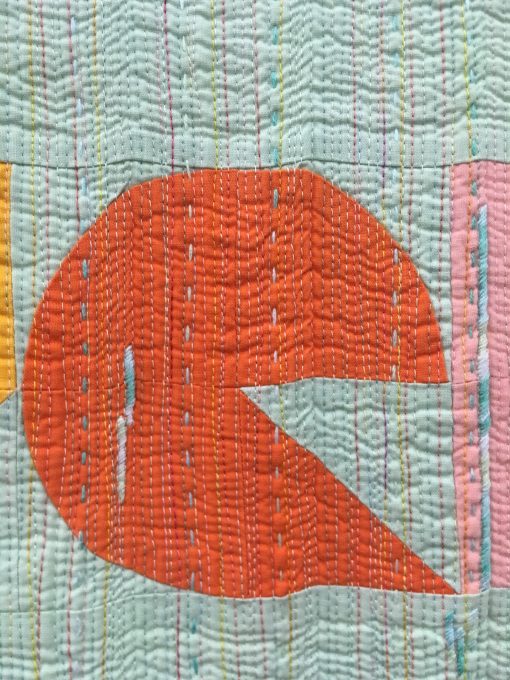 detail of “Naive” by Laura Hartrich @laurahartrich Statement: “Words from a favorite song, and an unofficial, cheeky motto for my quilt making. Quilters know that people are constantly asking if you sell your quilts, and then reacting with shock when you name a price. Here is another possible way to answer. I think it’s more polite than, ‘You can’t afford me.’” Modern quilt featured in the Handwork category at QuiltCon 2020 in Austin, Texas presented by the Modern Quilt Guild.