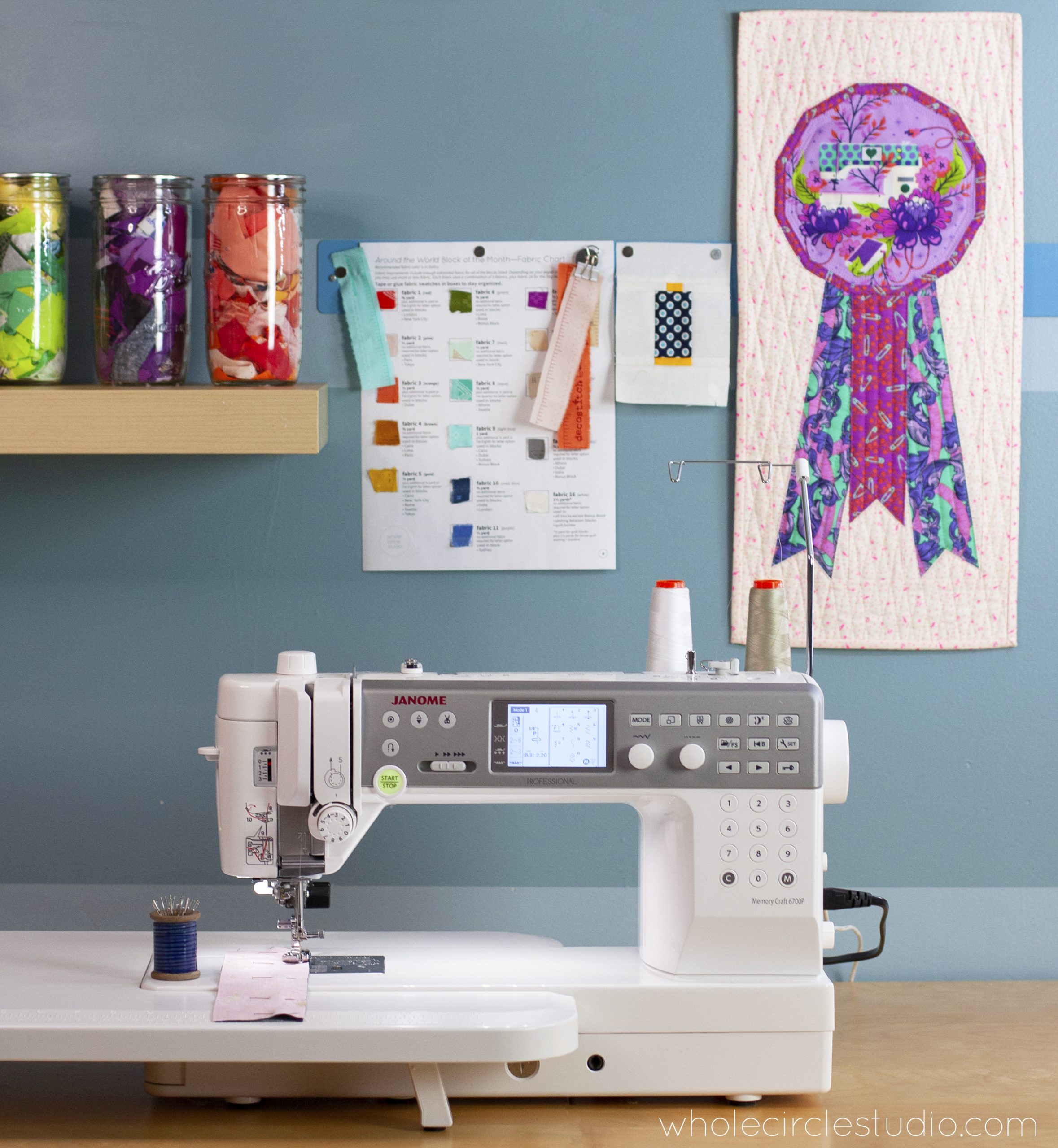 Inside the quilting space: Whole Circle Studio and their Janome 6700p. Quilt shown: Best in Show mini — pattern available at Whole Circle Studio