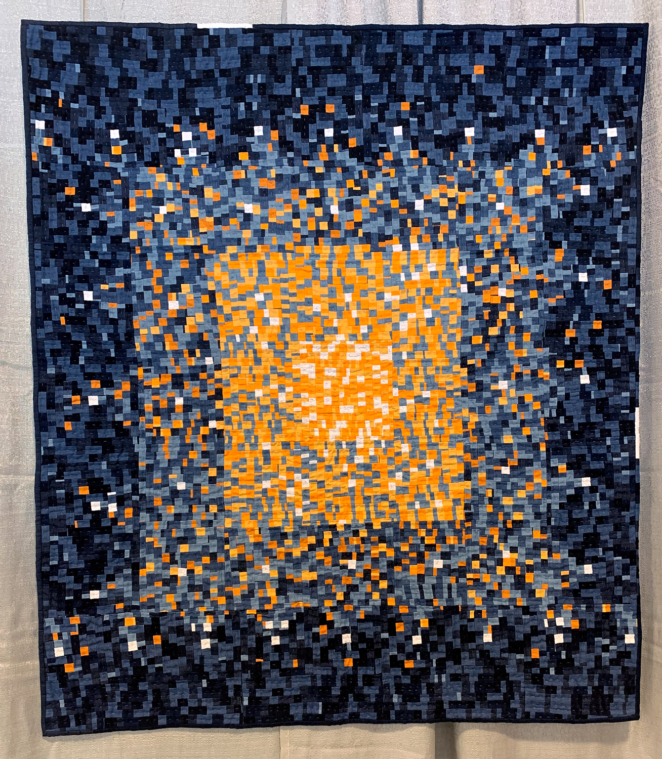 an improvisational quilt with orange and blue colors.