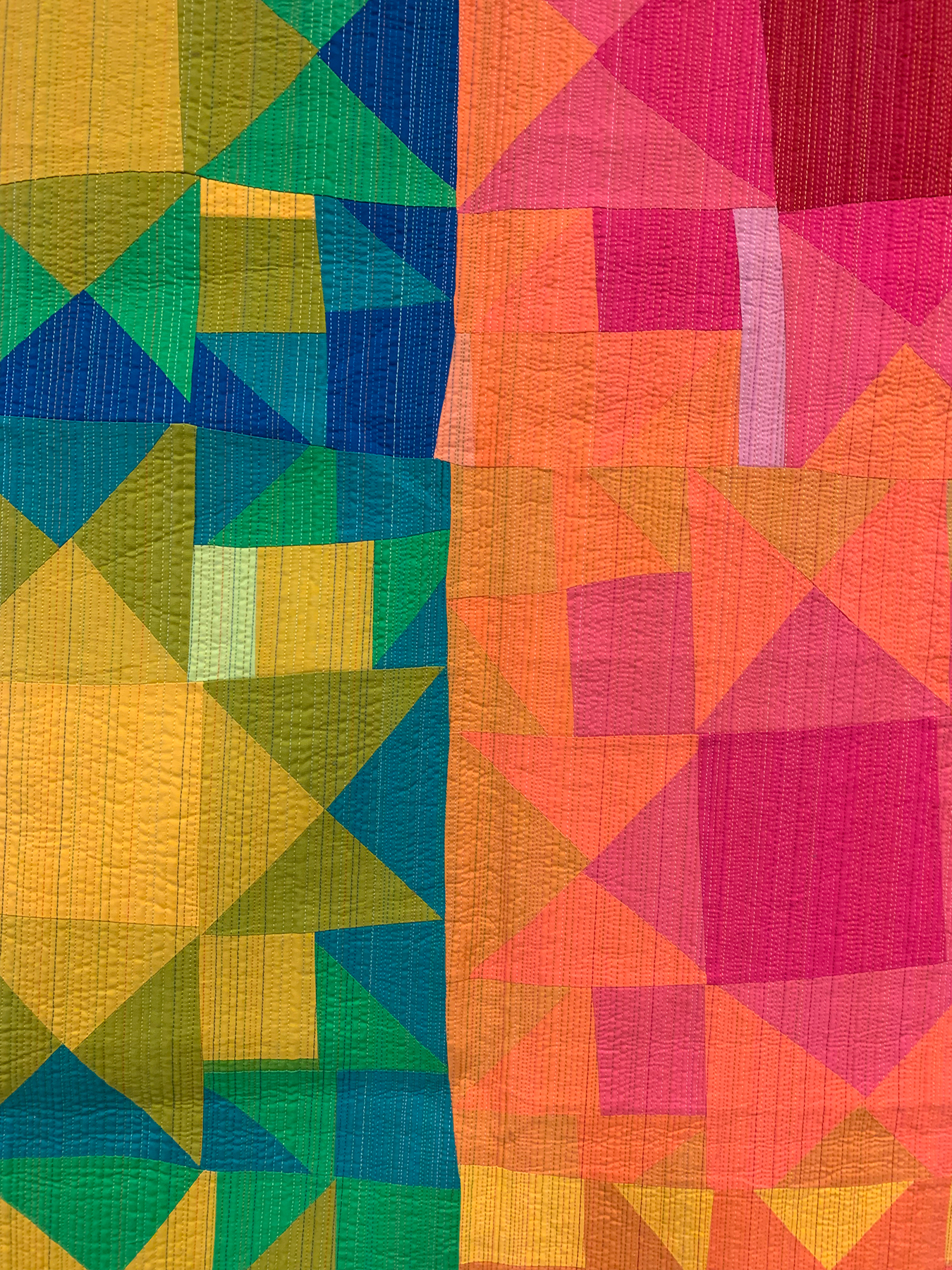 detail of a Colorful modern quilt with 16 wonky stars. 