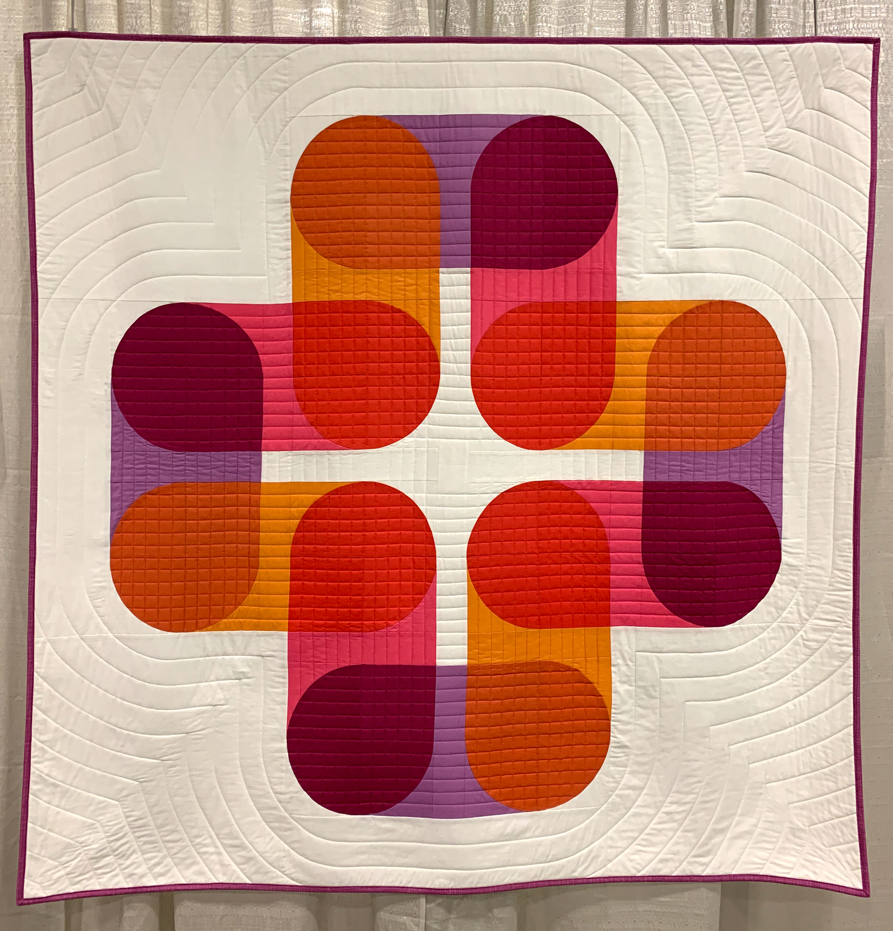 modern quilt with warm colors and curves