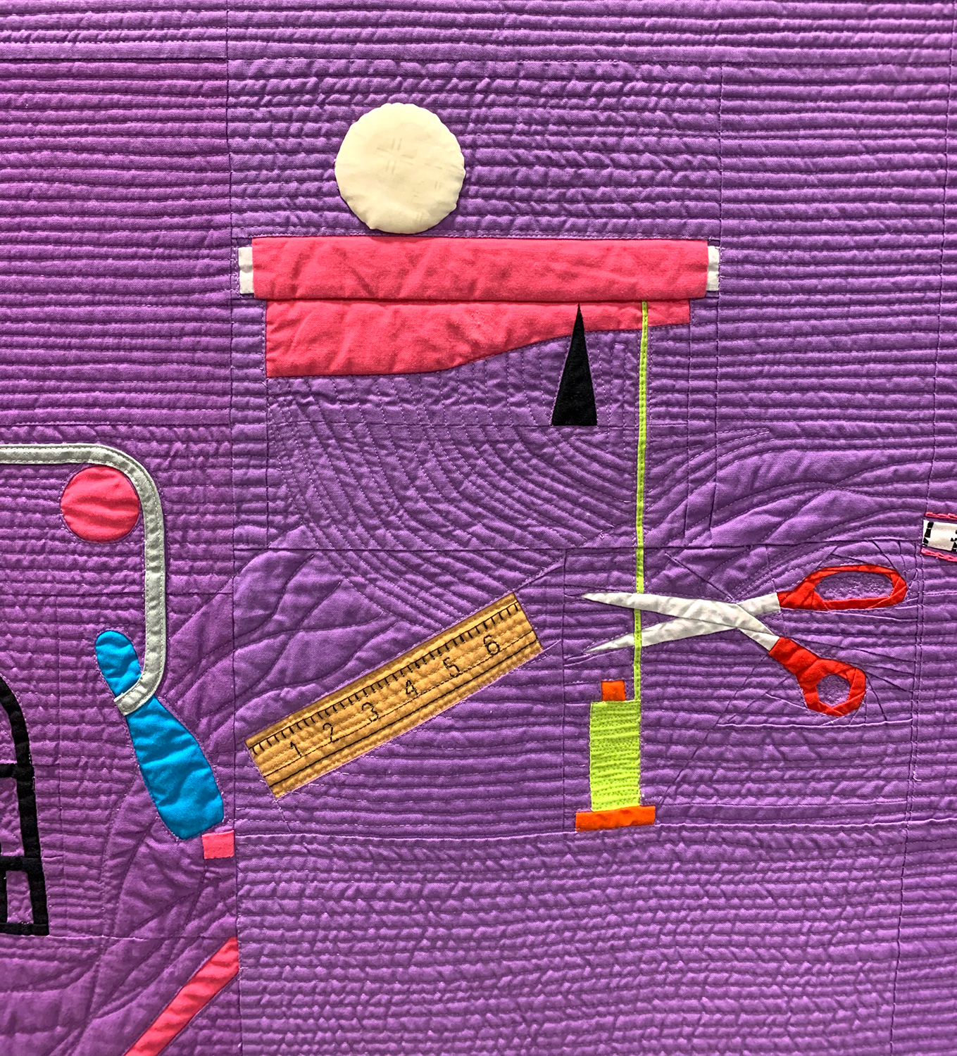 detail of a modern quilt that looks like a Rube Goldberg contraption