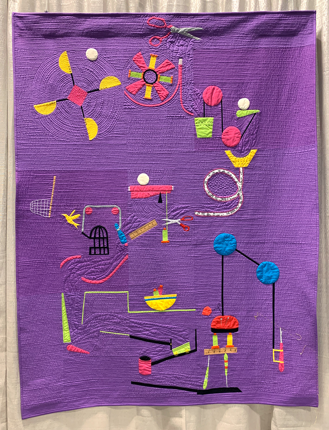 a modern quilt that looks like a Rube Goldberg contraption