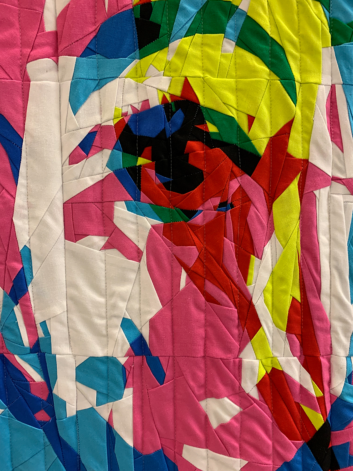 detail of modern quilt with 3 layered faces on a man: cyan, magenta, yellow