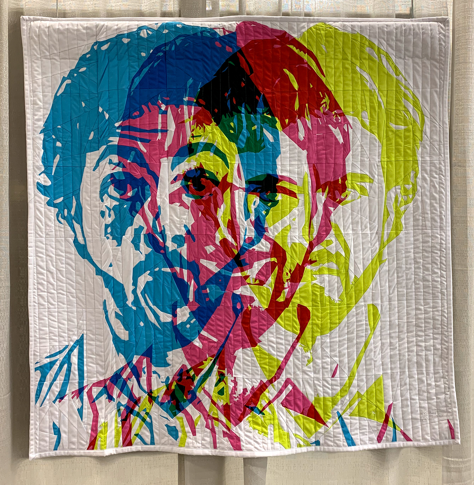 modern quilt with 3 layered faces on a man: cyan, magenta, yellow