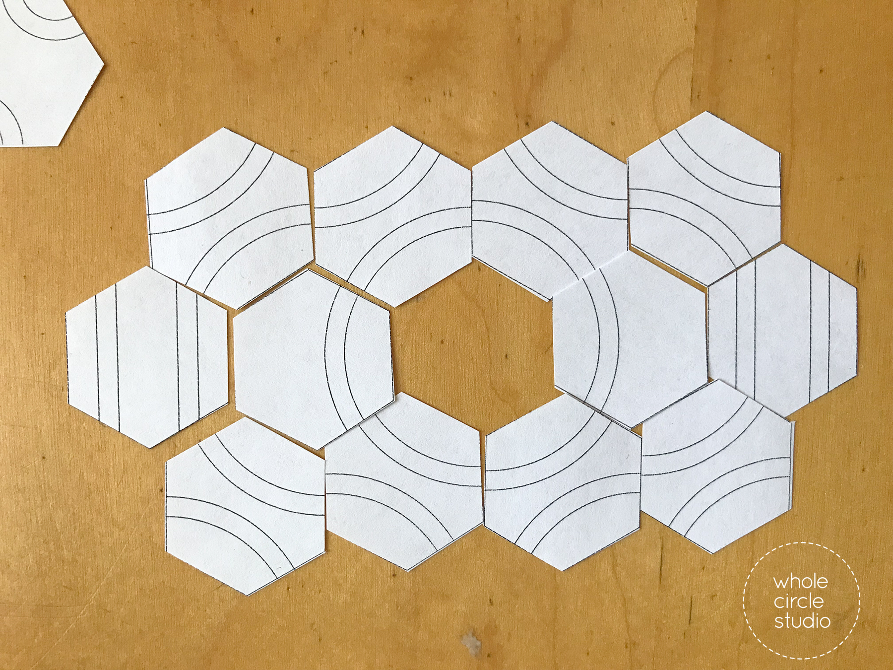 paper cutouts of hexagon quilt blocks