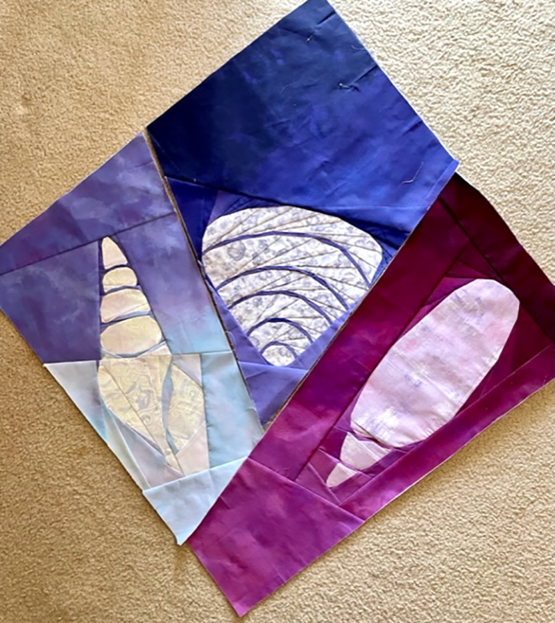 quilt top of 3 blocks that look like shells and sea glass