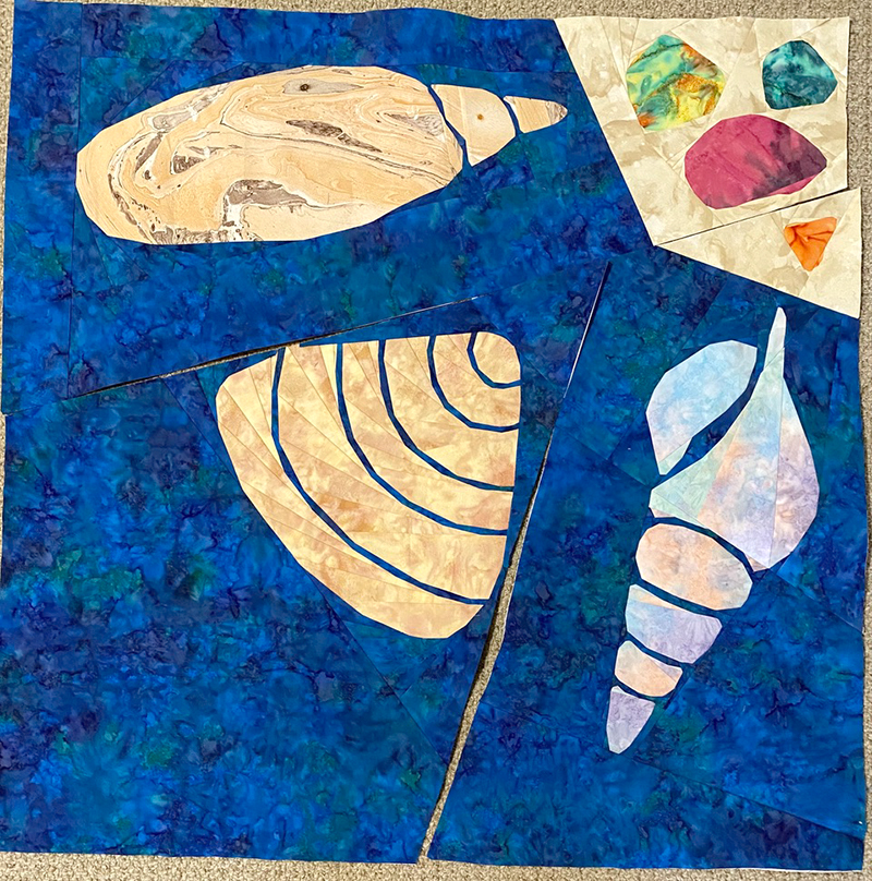quilt top of 3 blocks that look like shells and sea glass