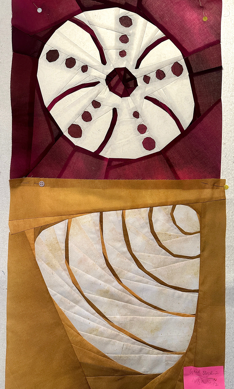 Two quilt blocks of sea shells. White shells on a dark red and dark yellow background