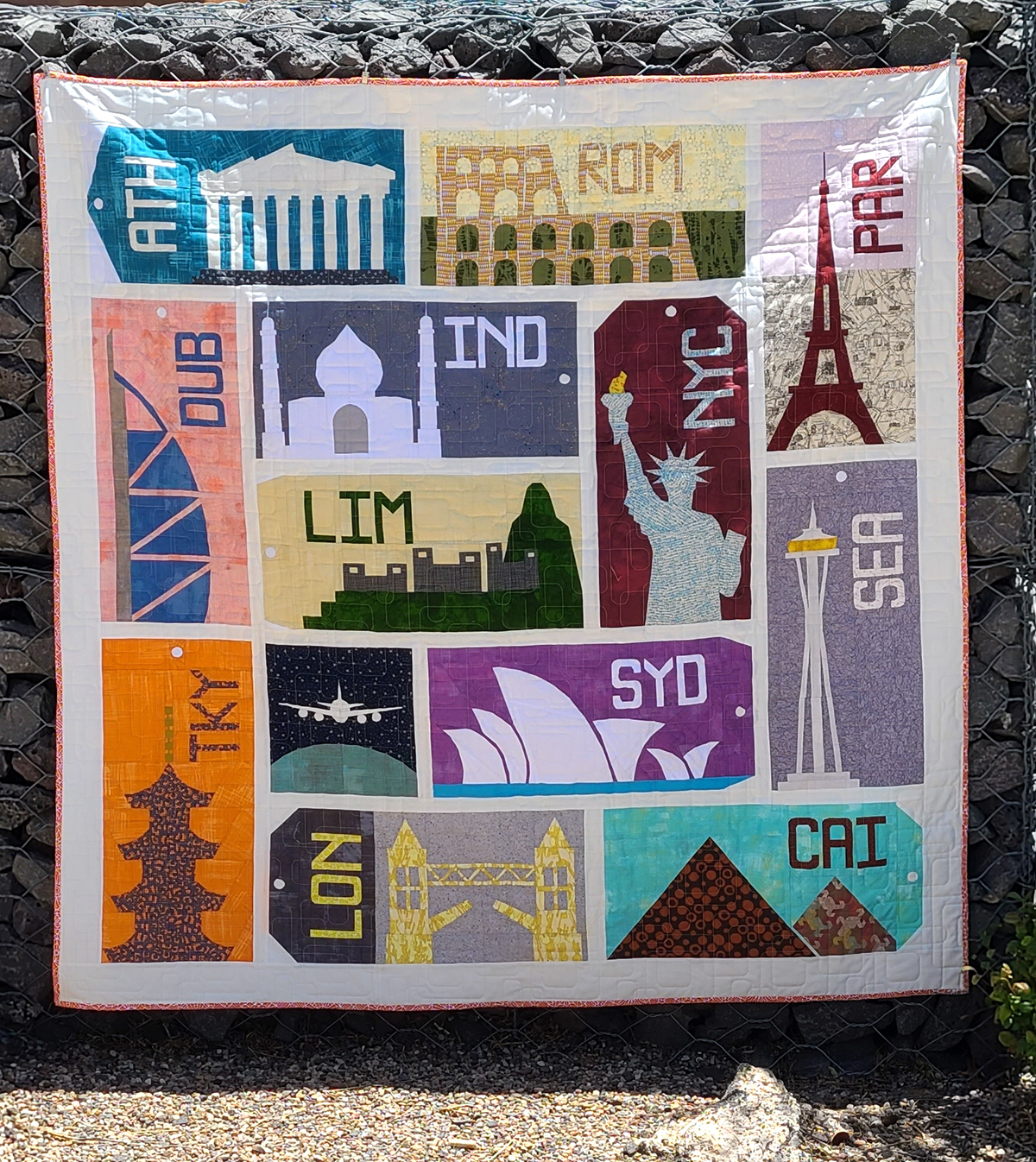 quilt with architectural structures from around the world