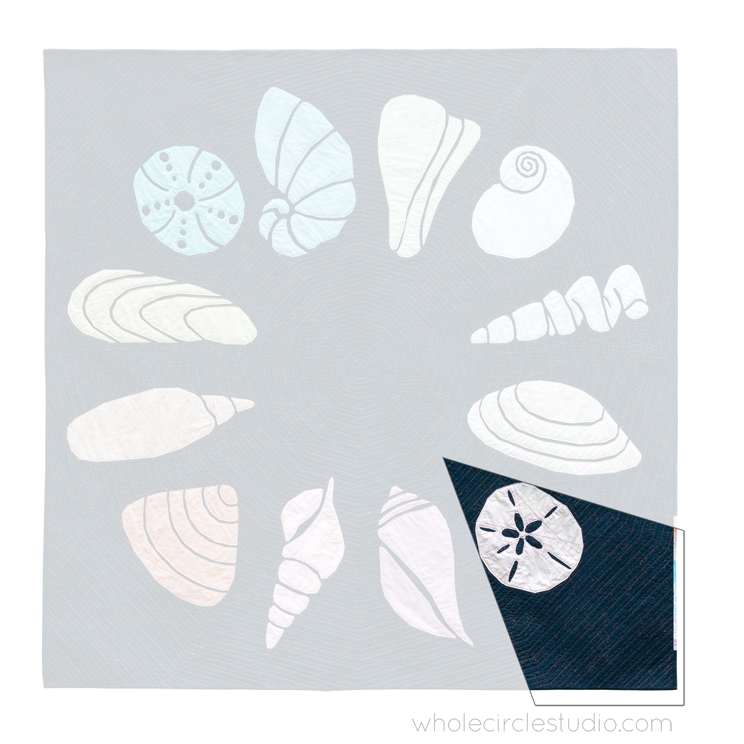 quilt of 12 abstract sea shells in a circle with one block of sand dollar highlighted