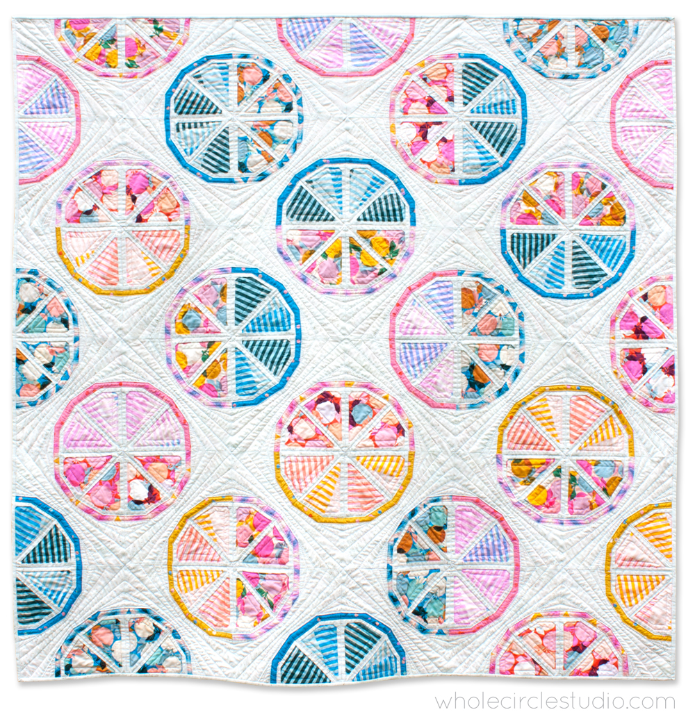 quilt of citrus-inspired blocks that look like slices of fruit
