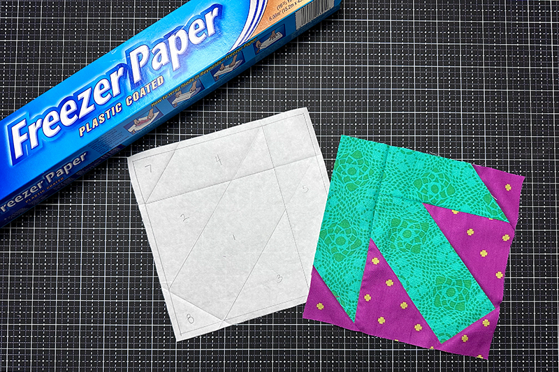 roll of freezer paper and quilt block