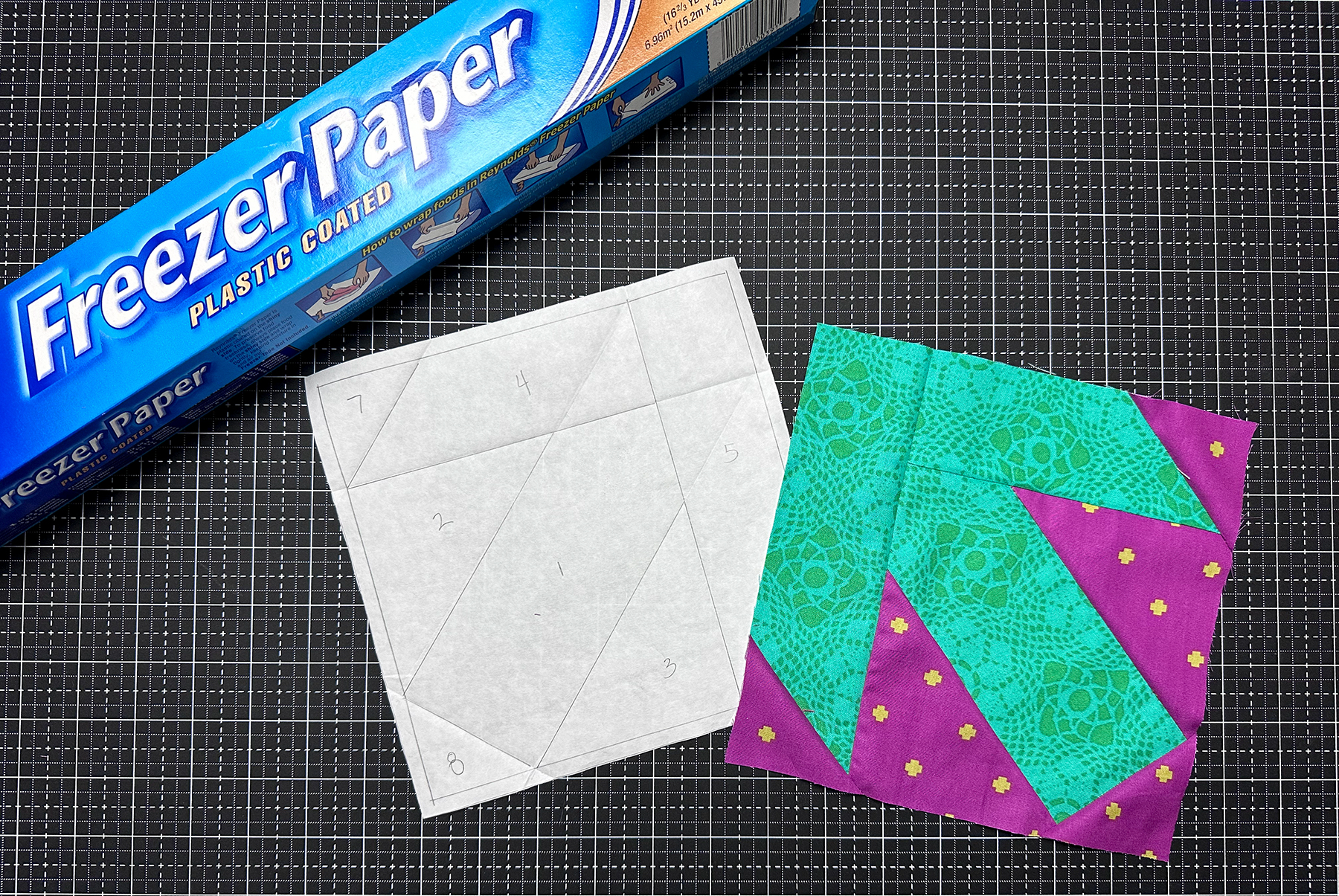 photo of a box of Freezer Paper with a quilt block